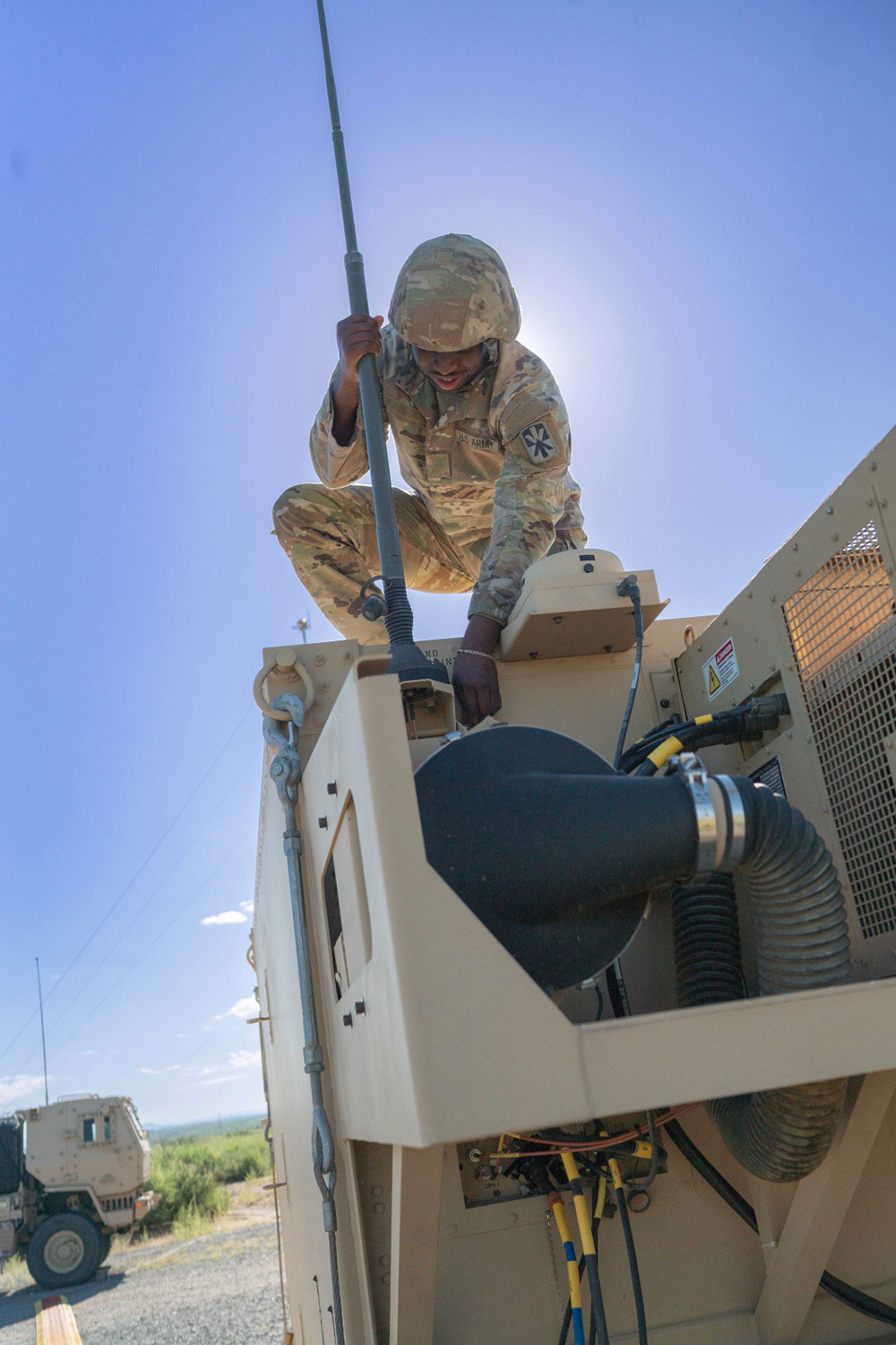 soldier working on military vehicle