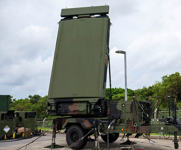 Military-grade mobile radar system mounted on a truck for battlefield surveillance and target detection.