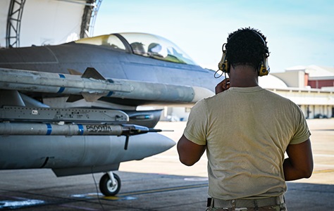 Airman monitors an F-16 Fighting Falcon equipped with the Integrated Viper Electronic Warfare Suite, highlighting advanced electronic warfare capabilities at Eglin Air Force Base.