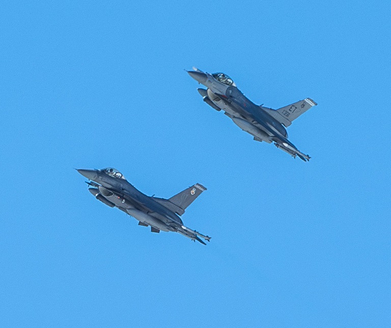two f-16 flying in blue sky