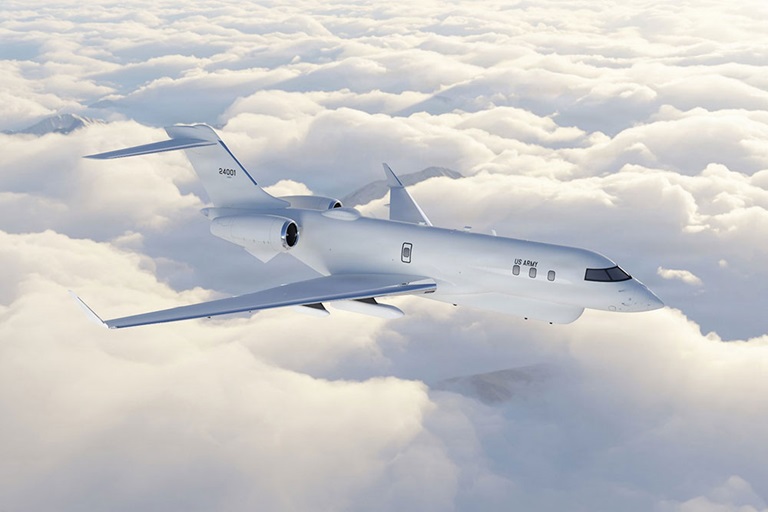 PM SAI - High Accuracy Detection and Exploitation System (HADES) US Army jet flying above dense clouds with mountains in the background, clear sky, and sunlight.