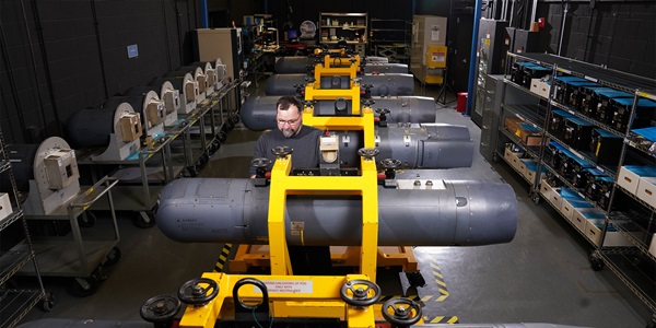 Modernizing Defense Technology employee working in defense technology manufacturing facility