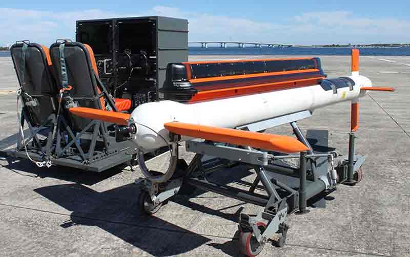 AQS-24B minehunting system on a launch platform, with two operator seats and control equipment visible in the background.