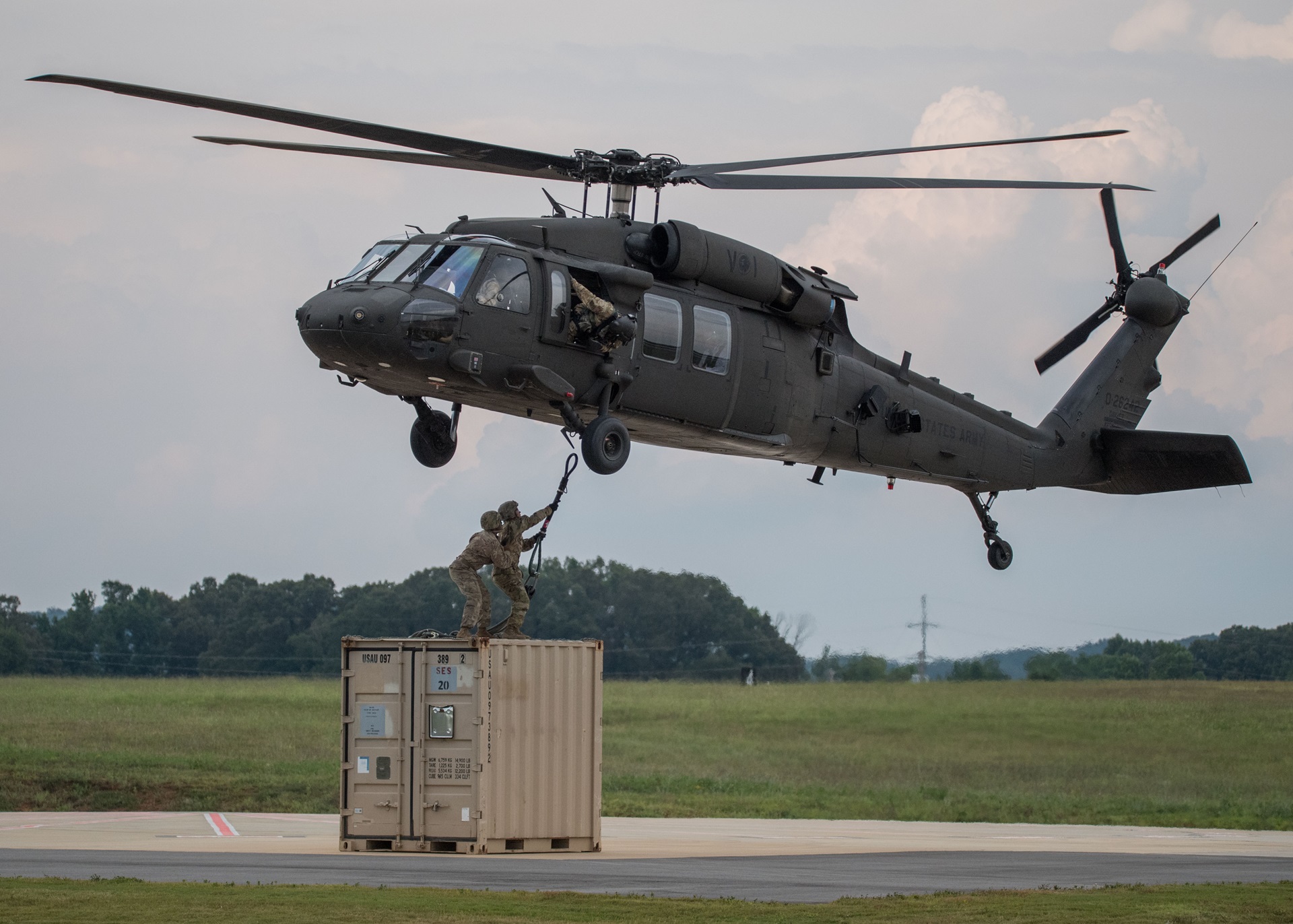 Soldiers Executing Limited User Testing Sling Mission soldiers hoisting equipment to military helicopter