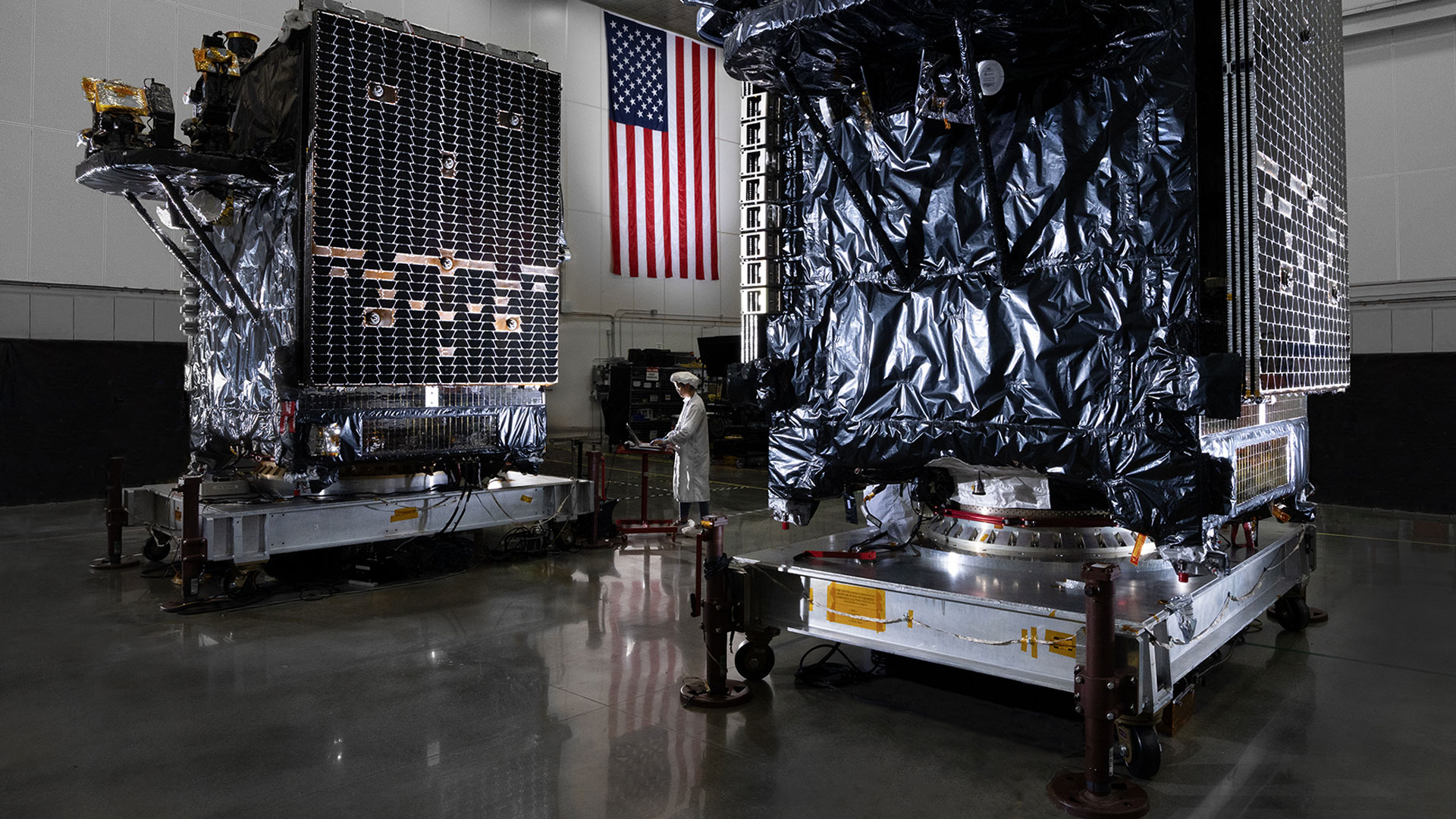 Arctic Broadband Satellite Mission manufacturing in lab with technician.