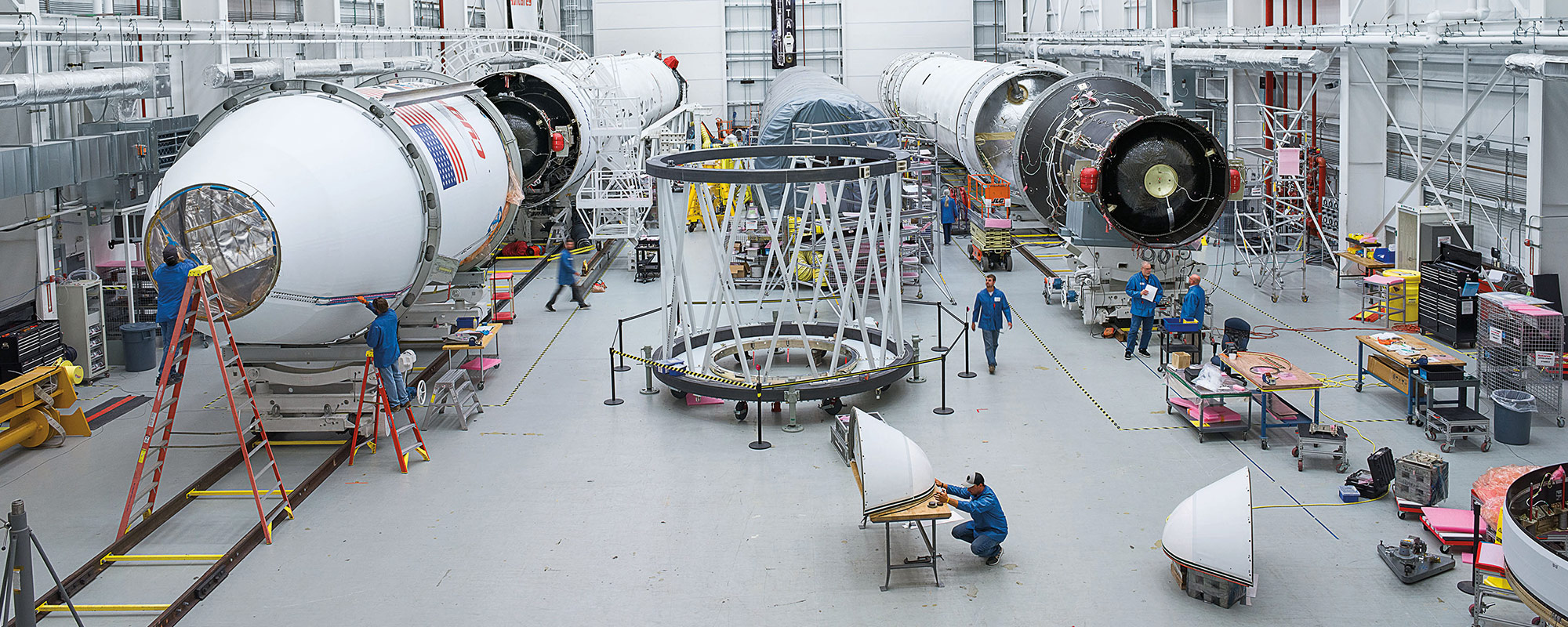 Workers with Antares rockets in space facility