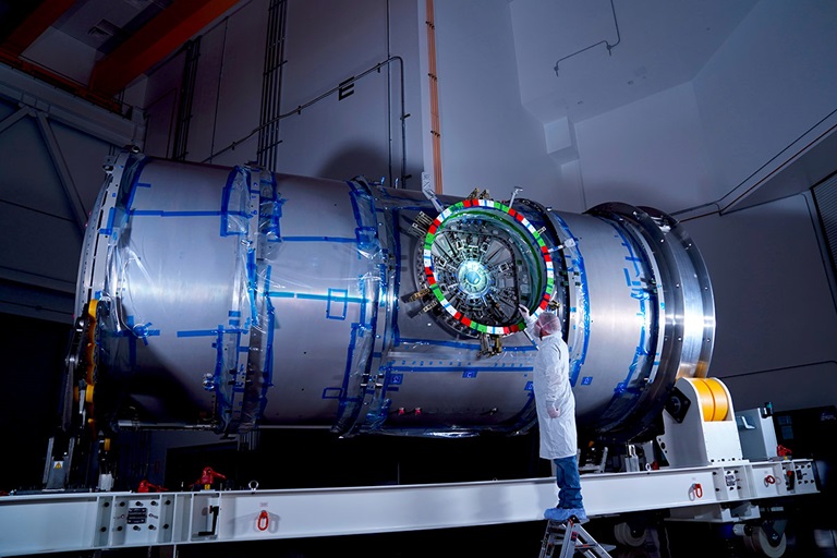 man working on HALO spacecraft in lab
