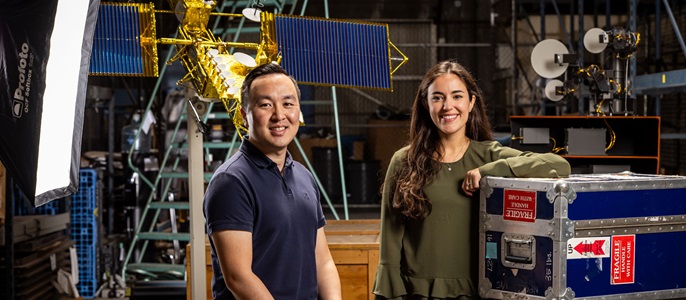 photo of two people in engineering lab smiling