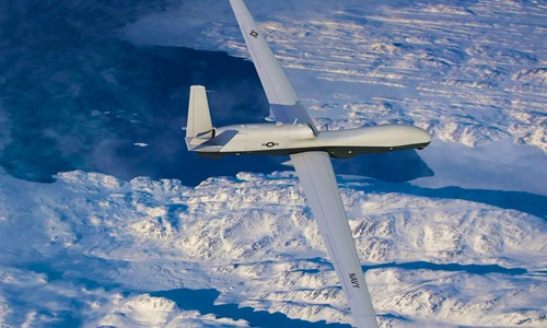 Triton unmanned aerial vehicle flying above snowy mountains