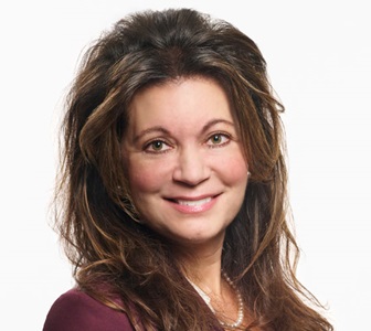 Photo of woman with brown hair smiling. 