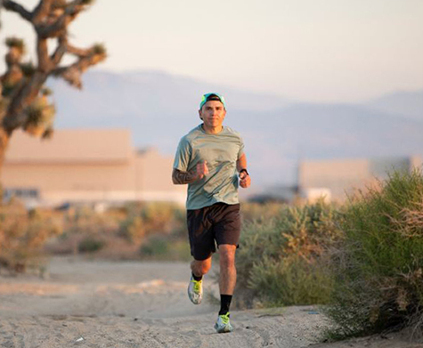 male running through desert