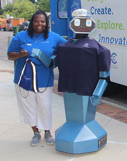 woman standing with a robot