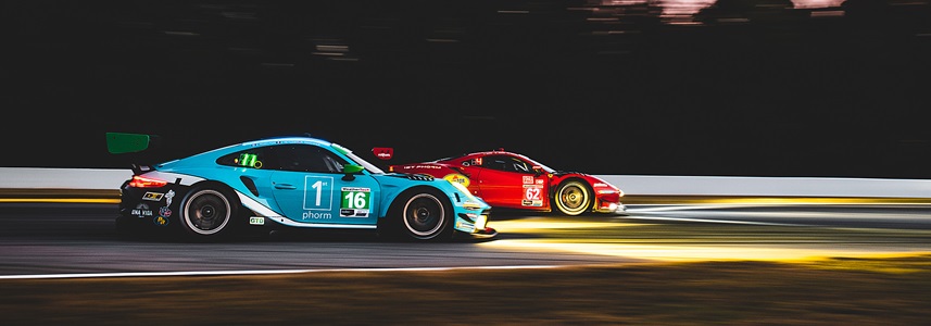 two race cars on track at night
