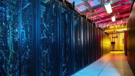 A blue and orange image of a hallways with servers.