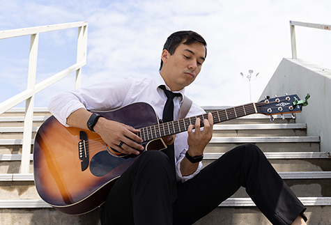 male playing guitar