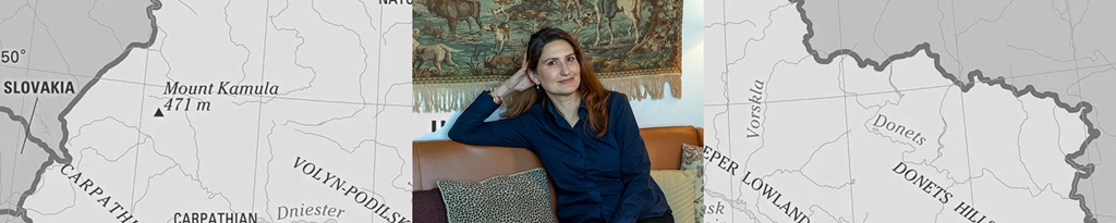 woman posed in chair with map in background