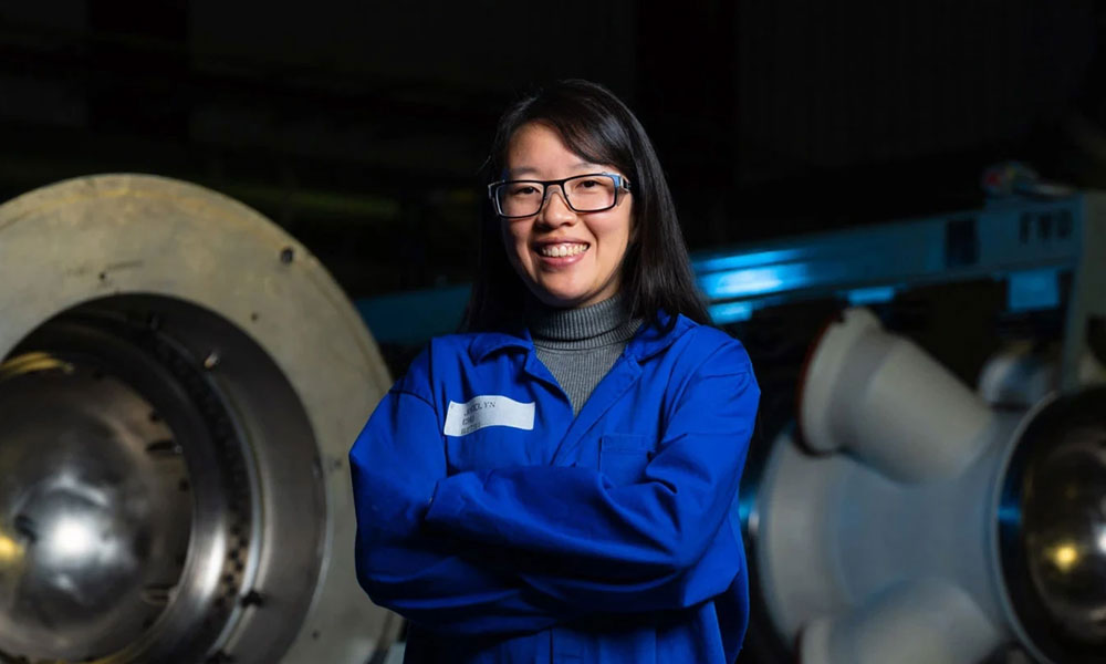 woman smiling in blue jumpsuit