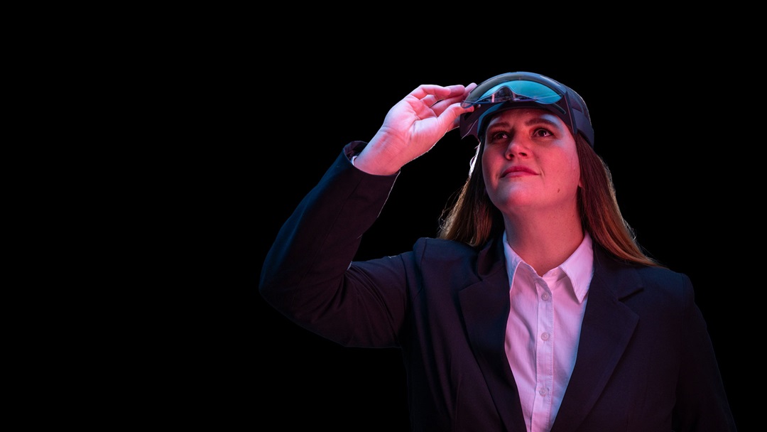 Woman looks up from virtual reality goggles. 