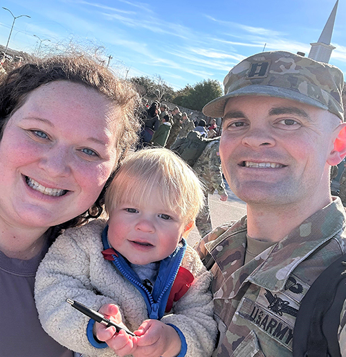 mother and father posed with their baby.