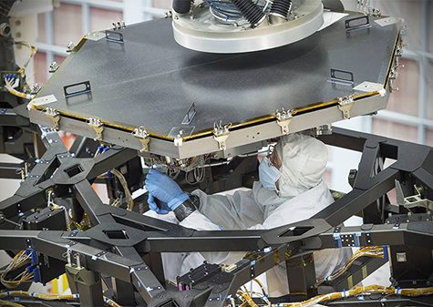 technician working on a telescope