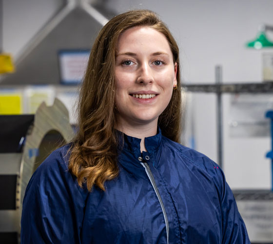 Image of woman in lab clothes smiling