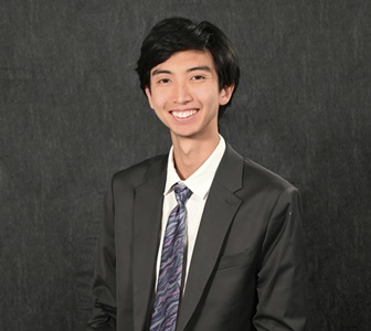 Photo of person in shirt and tie smiling