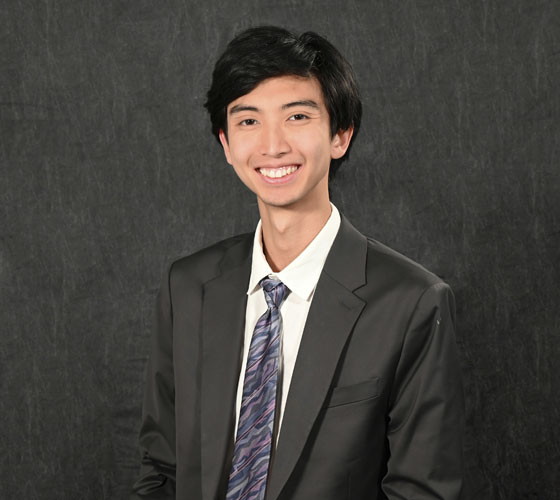 Photo of person in shirt and tie smiling