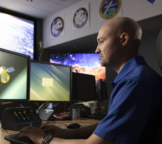 employee looking at double computer screens