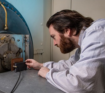 Man looks at lab equipment