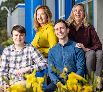 Picture of smiling family in group photo. 