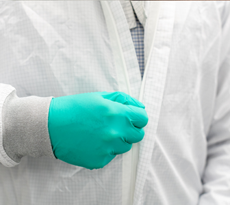 Image of man zipping up clean room cover.