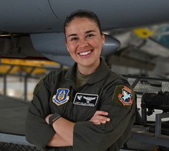 female military pilot in flight uniform smiling