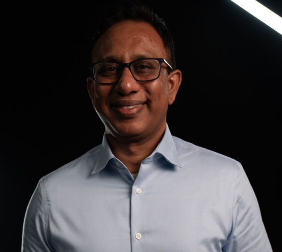 Man smiling on black background