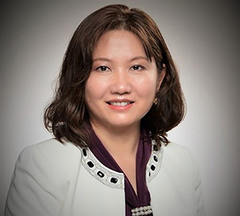 The Process for Precision Professional portrait of a female engineer in a white jacket, representing innovation and leadership in microelectronics at Northrop Grumman.