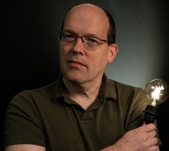 man smiling on black background