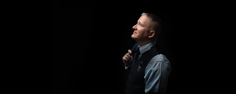 Man looking up on black background.