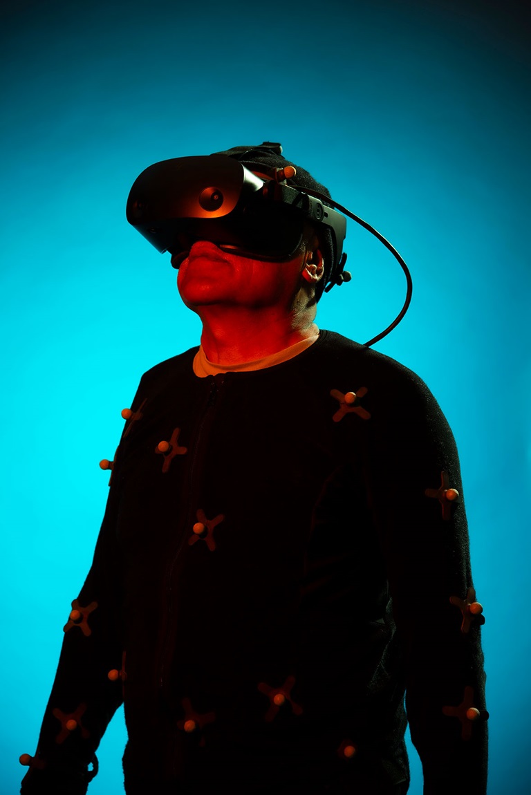 Man wearing HIVE body suit in a dark room