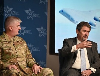 two males speaking on a panel