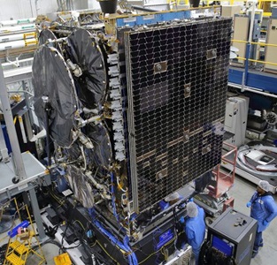 technicians in highbay working on a satellite