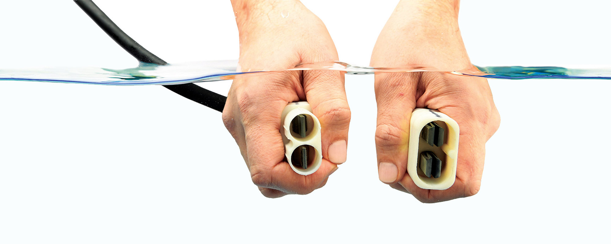 Mixing Electricity with Water Northrop Grumman Hands underwater connecting electrical cords
