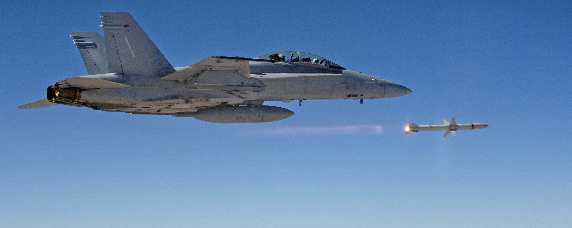 aircraft firing a missile in the blue sky