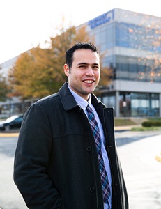 man in suit standing outside office building