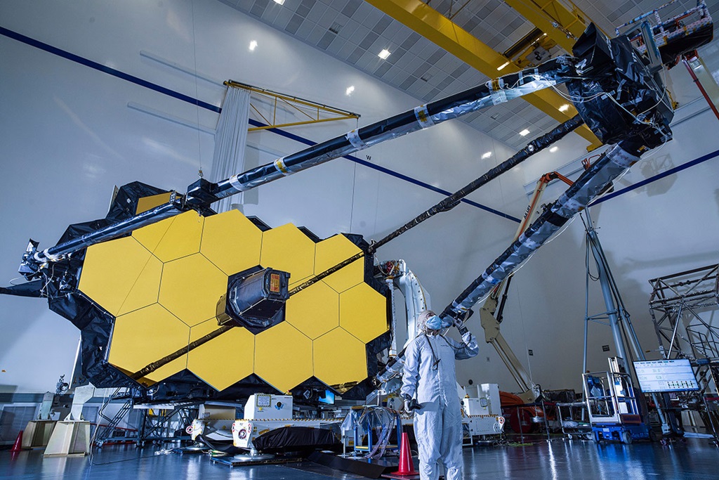 Engineer in clean suit testing Webb Telescope