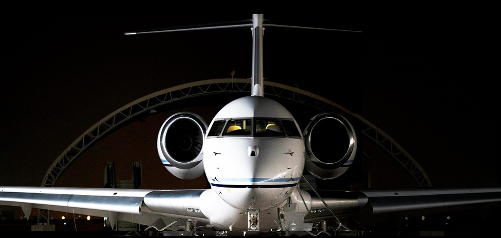 E-11A aircrraft sitting on runway at night