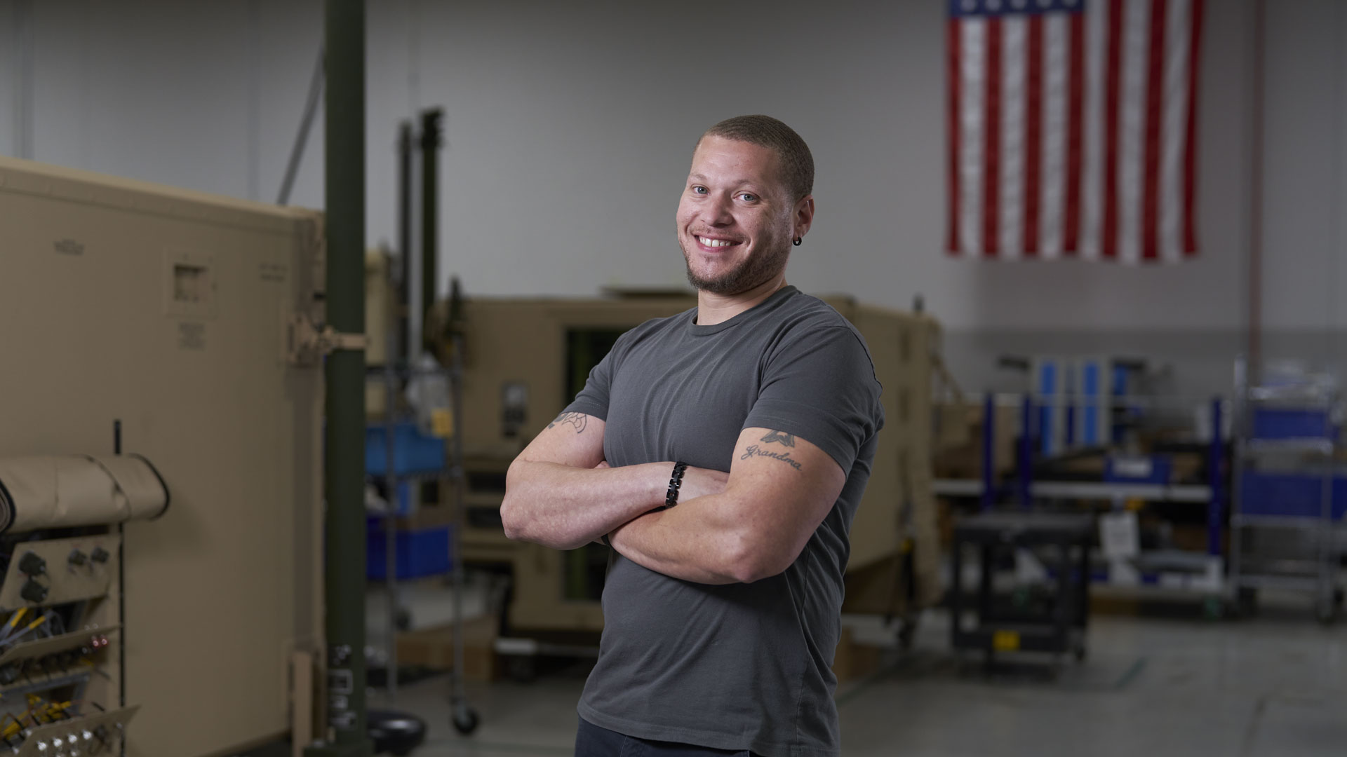 Man standing with crossed arms inside.