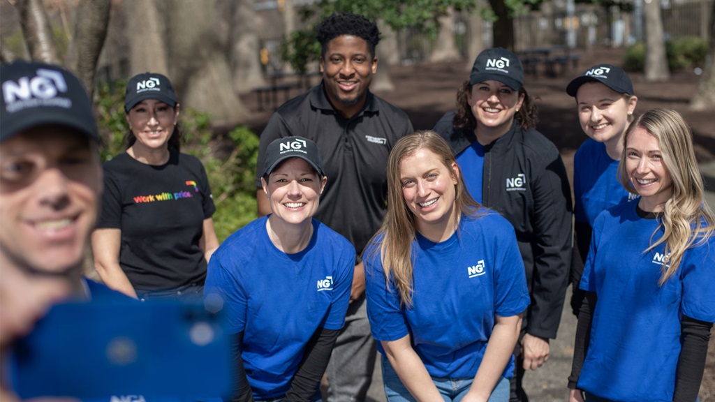 Diverse group of employees taking a selfie and smiling. 