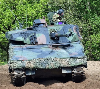green tank with bushmaster chain gun
