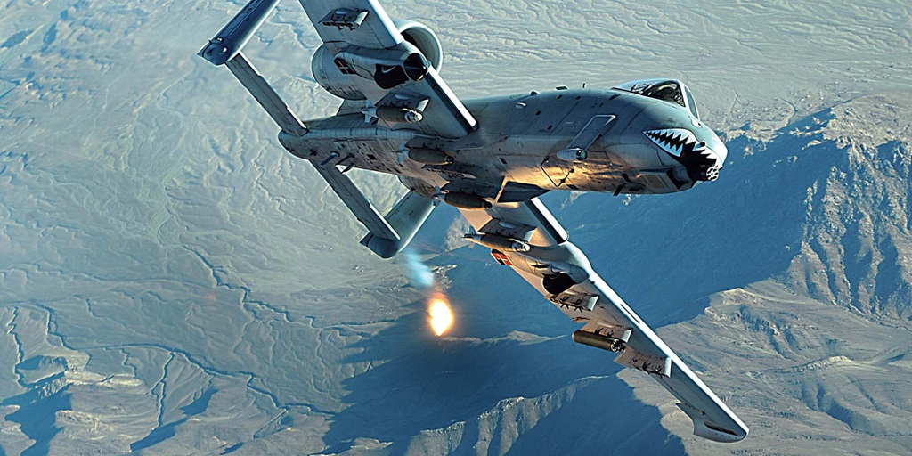 A-10 Thunderbolt banking above a mountain range