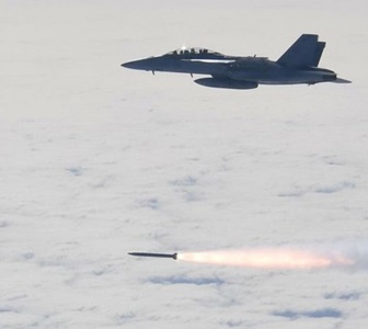 fighter jet in flight while launching a missile