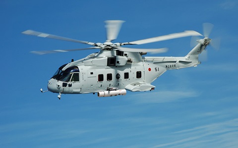 Military helicopter flying against clear blue sky, showcasing advanced aviation technology and design.